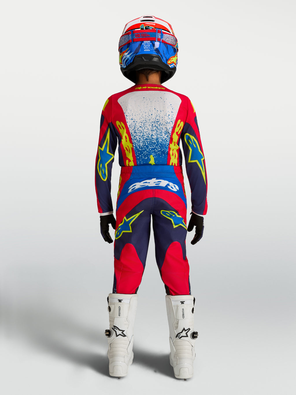 Alpinestars 2027 Youth Fluid Drag Jersey, Navy Blue and Fire Red motocross gear, rear view on rider with matching pants.