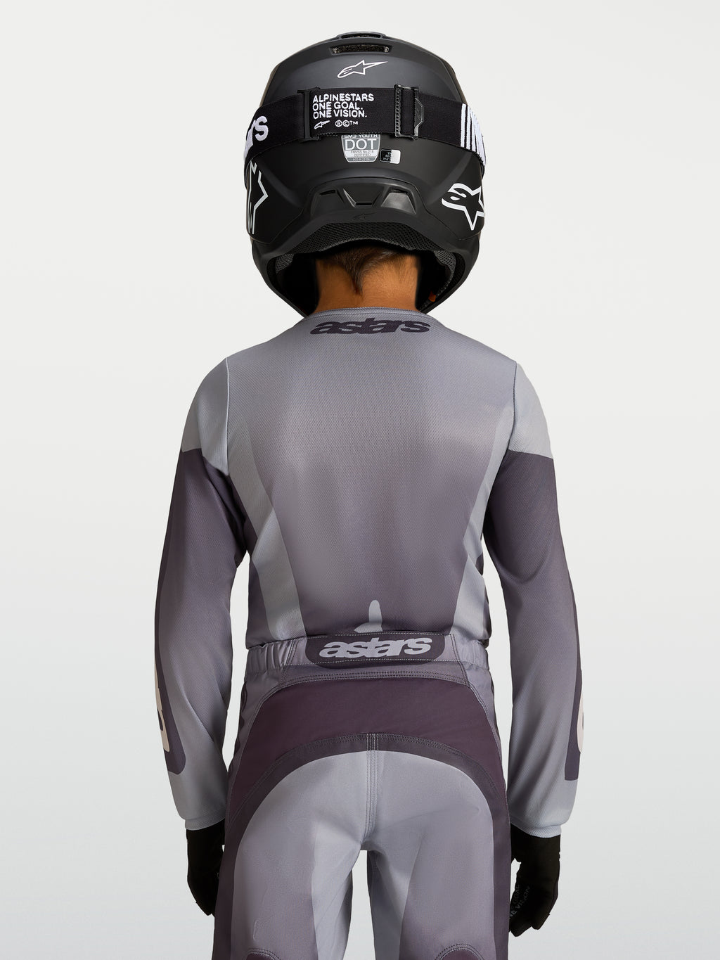 Alpinestars Jeugd Fluid Amber Jersey, motorcrossjersey voor kinderen, zand en grijs, achteraanzicht van een jonge rijder.