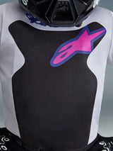 Alpinestars 2026 Youth Fluid Grid Jersey, Motocross Jersey, Black and Light Gray, featuring a pink Alpinestars logo with a blue border on the chest, close-up showing the moisture-wicking fabric texture, part of a coordinated youth racing outfit