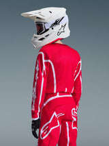 Alpinestars 2026 Youth Fluid Apex Jersey in Red and White, youth motocross jersey worn with matching gear and white helmet, back view showing athletic fit and white Alpinestars branding on sleeve and pants