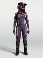 Alpinestars Stella Fluid Apex V2 broek voor dames, grijze en roze motorcrossbroek met bijpassende jersey en helm.
