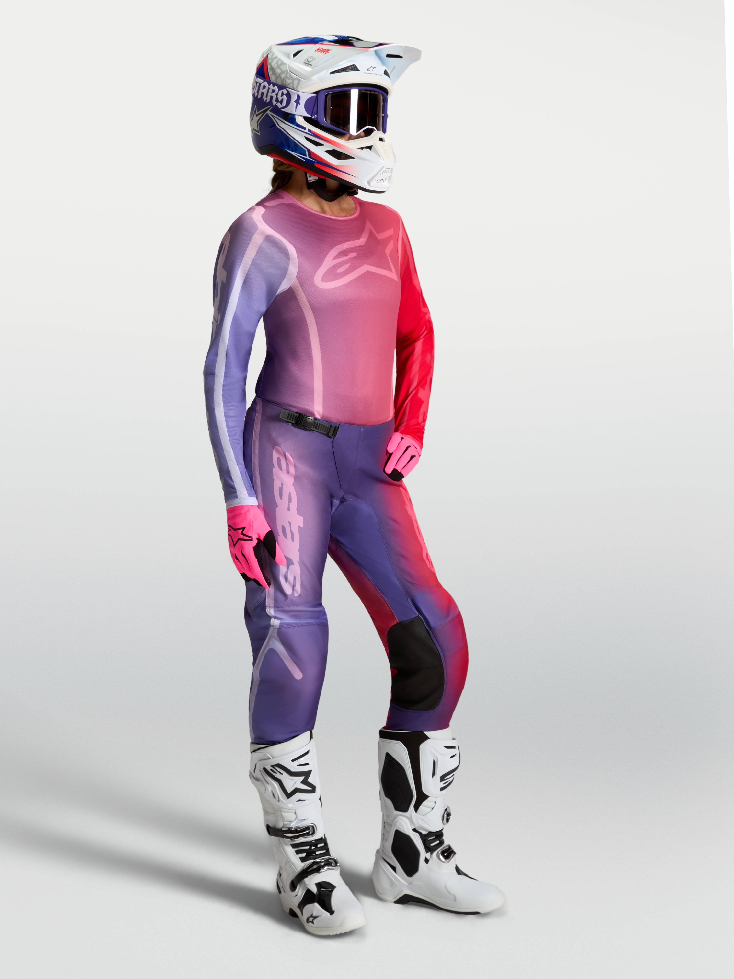 Alpinestars Stella Fluid Kepler dames-jersey voor motocross in paars en rood, met bijpassende broek en witte laarzen.