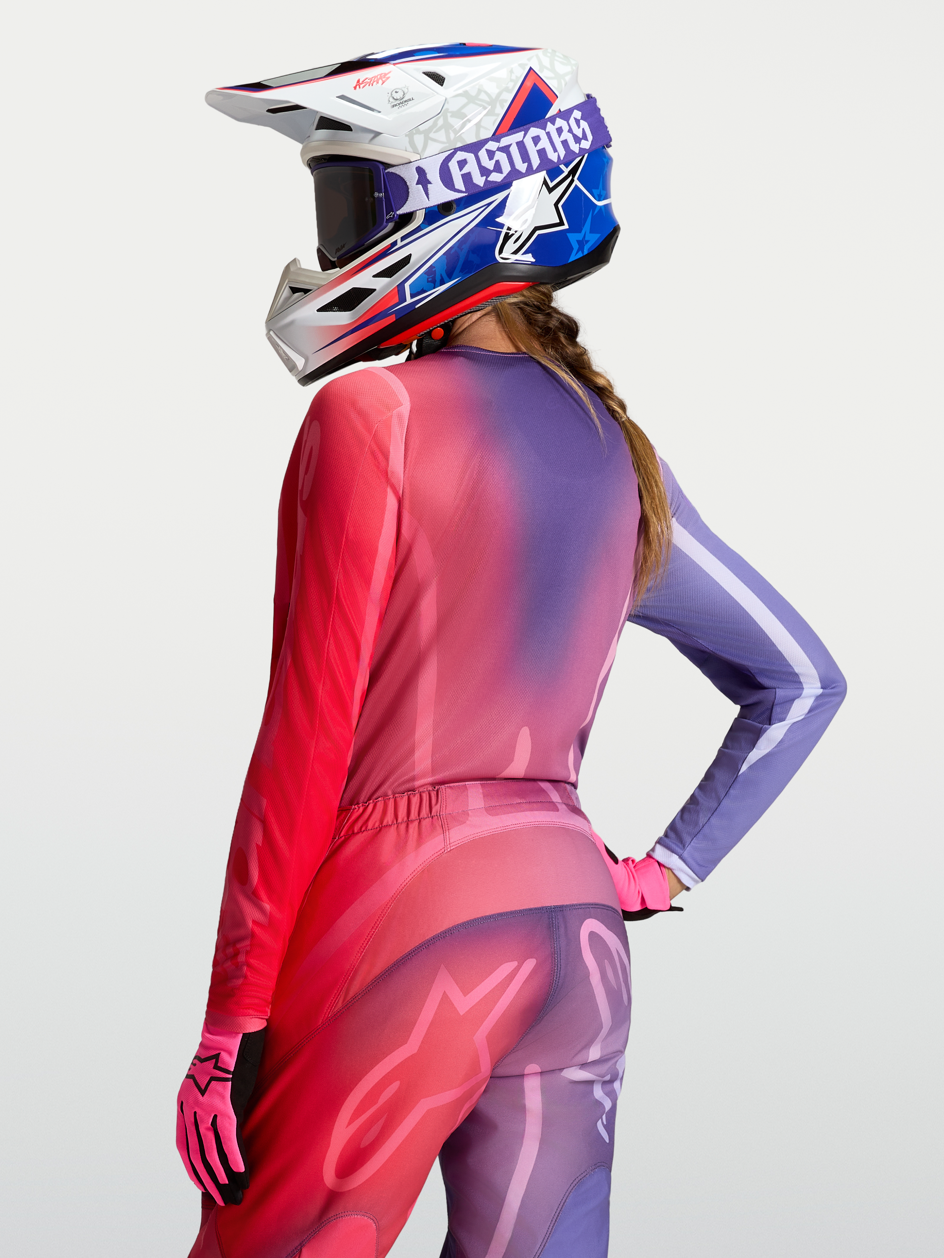 Alpinestars Stella Fluid Kepler jersey, dames motocross-jersey met paars en rood kleurverloop, nauwsluitende pasvorm en verlengde achterzijde.