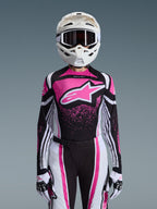 Alpinestars 2026 Stella Techstar Nomur Gear Set, Women's Motocross Outfit, Pink Black and White with large star logo, featuring matching jersey, pants, and gloves with a white helmet, front view on a grey background