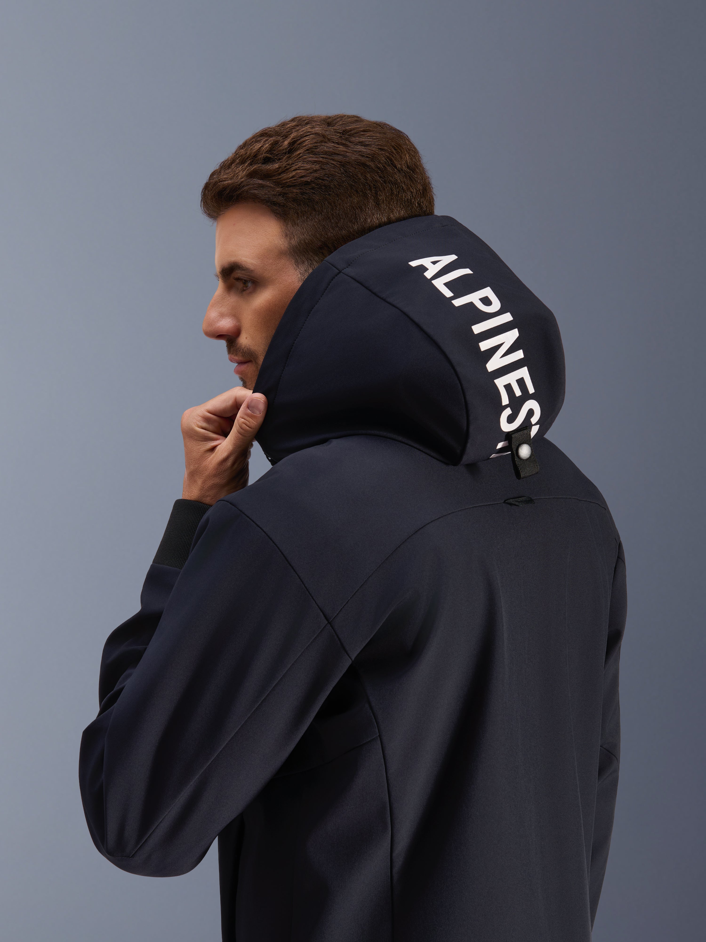 Alpinestars Radium Tech Hoodie, black urban motorcycle jacket for men, with white logo on the hood and windproof 3L shell.