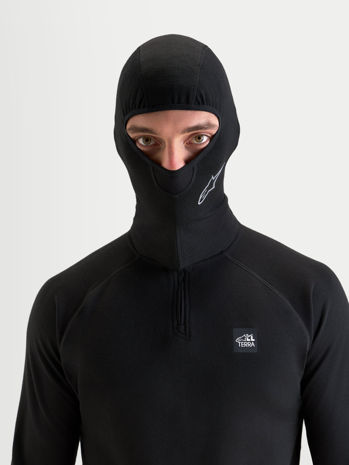 Alpinestars AT-8 Merino Balaclava, motorcycle and all-terrain adventure balaclava, black, worn by a model showing merino-blend thermal regulation and under-helmet comfort