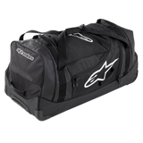 Alpinestars Komodo Reistas, grote reistas voor uitrusting, zwart met witte Alpinestars-logo's, voorzien van stevige wielen, versterkte handgrepen en meerdere compartimenten met ritssluiting voor het georganiseerd opbergen van race-uitrusting
