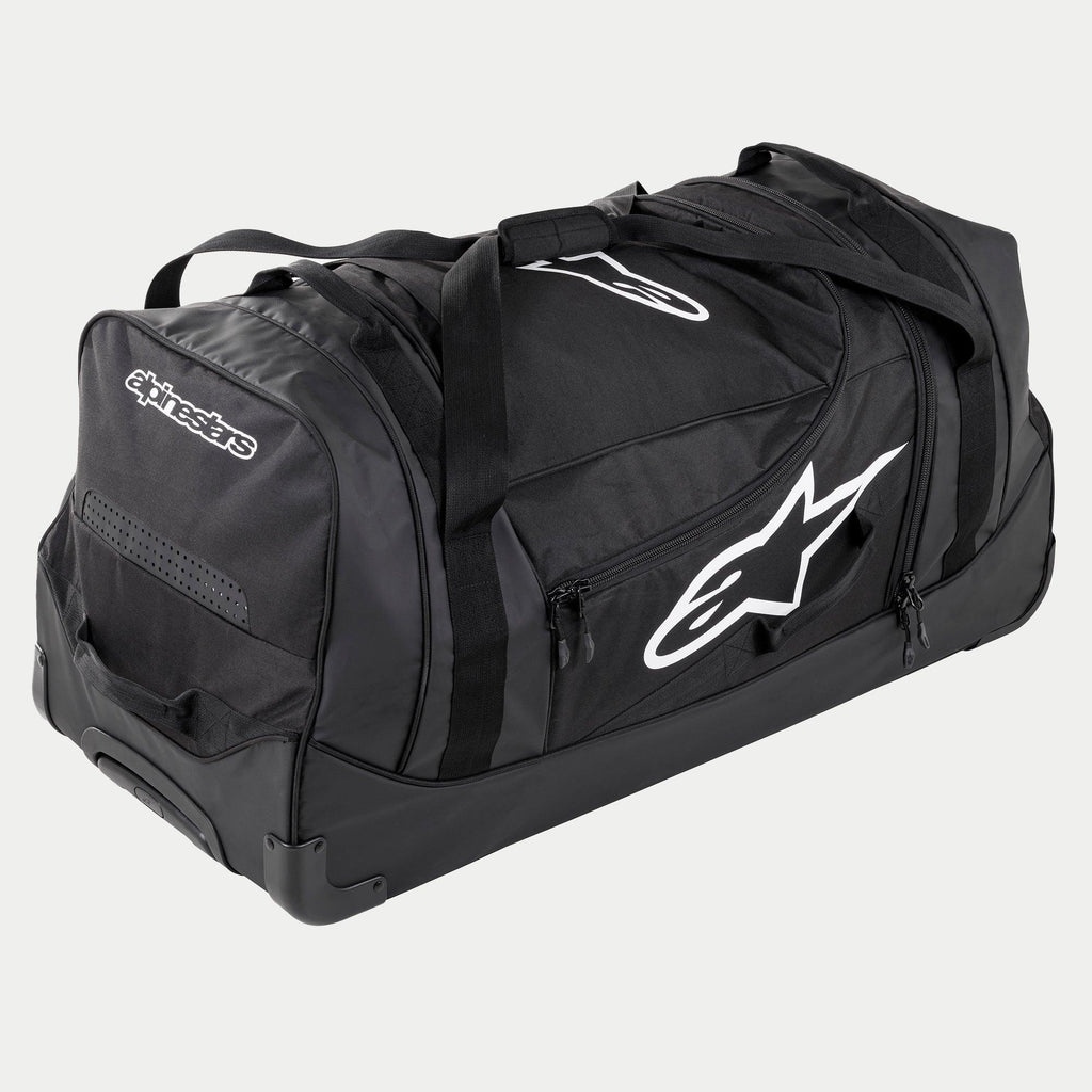 Alpinestars Komodo Reistas, grote motorcross uitrustingstas in zwart en antraciet met witte logo's, voorzien van wielen en een telescopisch handvat, duurzame constructie voor transport van race-uitrusting
