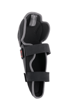 Alpinestars Bionic Action kniebeschermer, motorcross kniebescherming, zwart en grijs, binnenaanzicht met dubbel elastisch bandsysteem, schuimvulling en ergonomisch asymmetrisch ontwerp voor off-road rijden