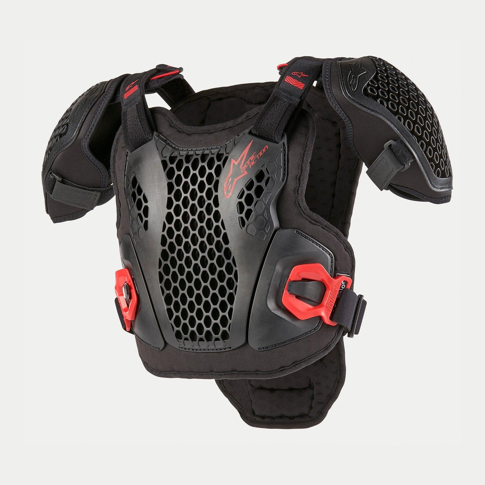 Alpinestars Youth Bionic Action Chest Protector, Motocross Body Armor, Black and Red, featuring perforated Cell Technology grid plates, adjustable shoulder straps, red quick-connect buckles, and padded chassis for youth off-road riding