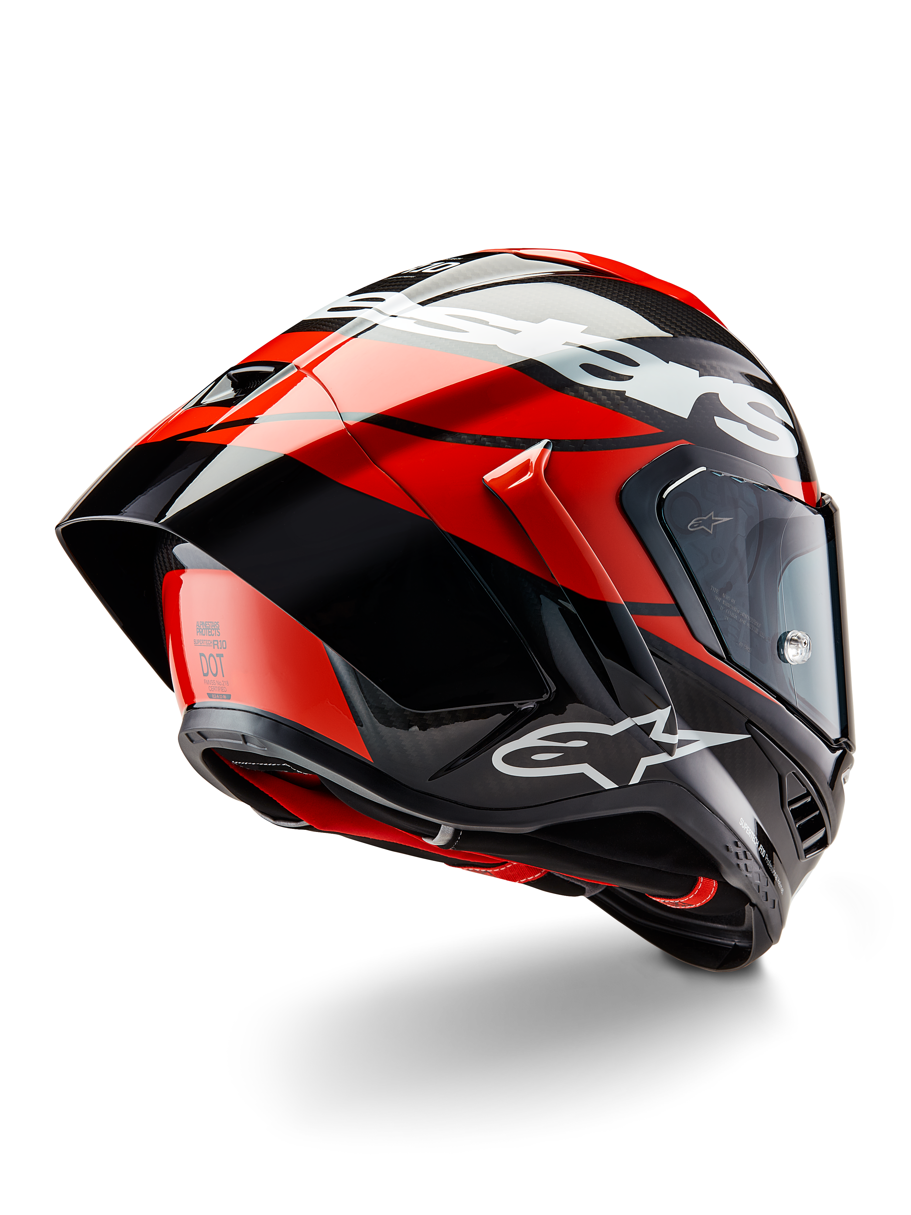 Alpinestars Supertech R10 Element helm, zwart carbon, felrood en glanzend wit, driekwart achteraanzicht met grote aerodynamische spoiler en carbonvezel schaal, voorzien van opvallende Alpinestars-logo's en DOT-certificering