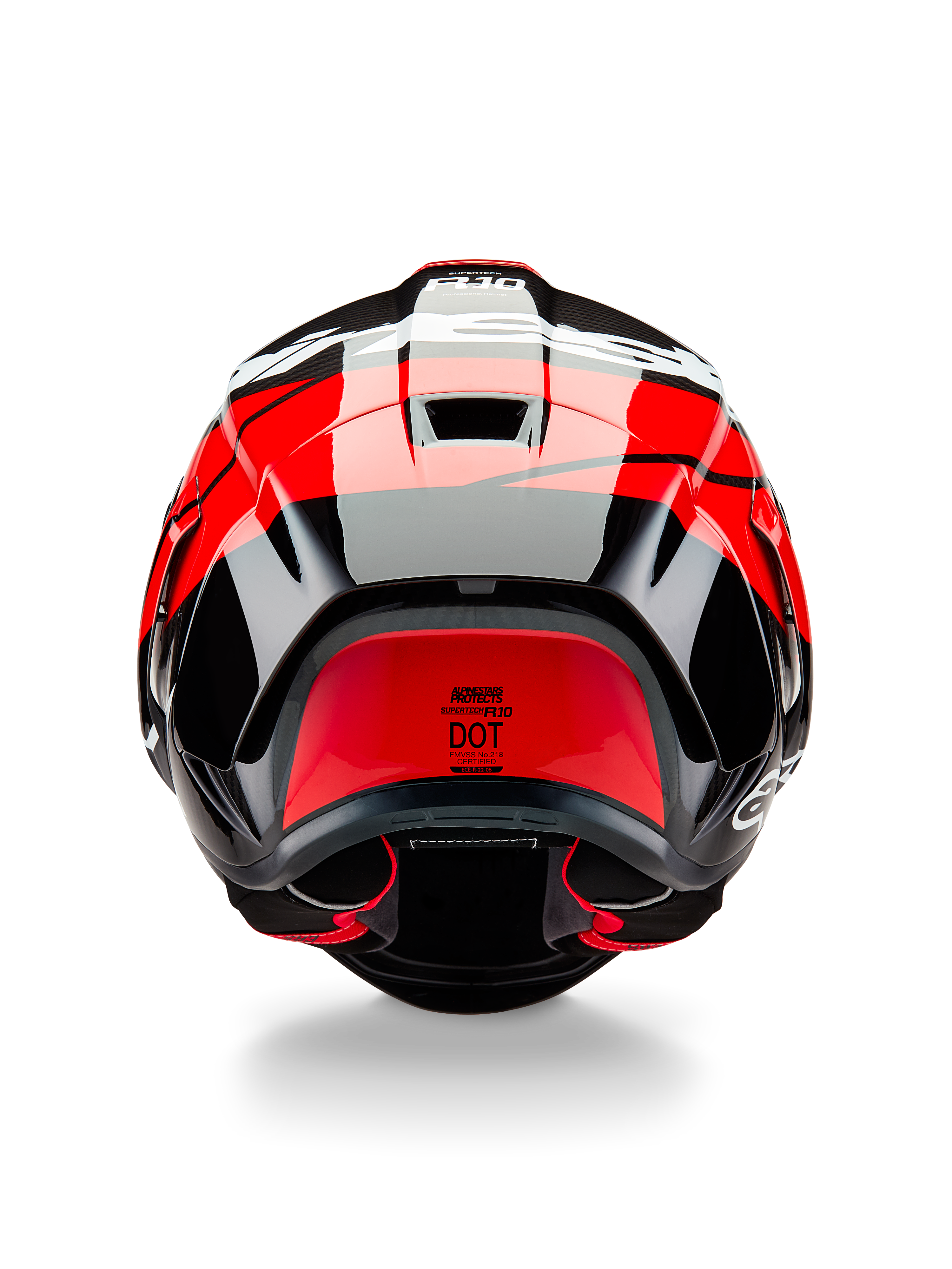 Alpinestars Supertech R10 Element helm, achteraanzicht, zwart carbon met felrode en witte glanzende accenten, voorzien van een aerodynamische achterspoiler, ventilatieopeningen en DOT-certificeringslabel, strak race-geïnspireerd ontwerp met carbonfiber details
