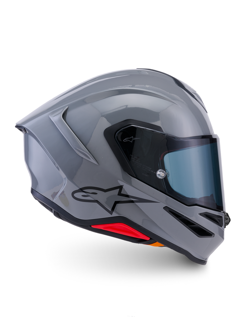 Alpinestars S-R7 Solid helm, integraalhelm voor de motor, glanzend grijs, zijaanzicht, glanzend grijze aerodynamische schaal met zwart logo en rode accenten aan de basis, hoogwaardige uitrusting voor racen en sportief rijden