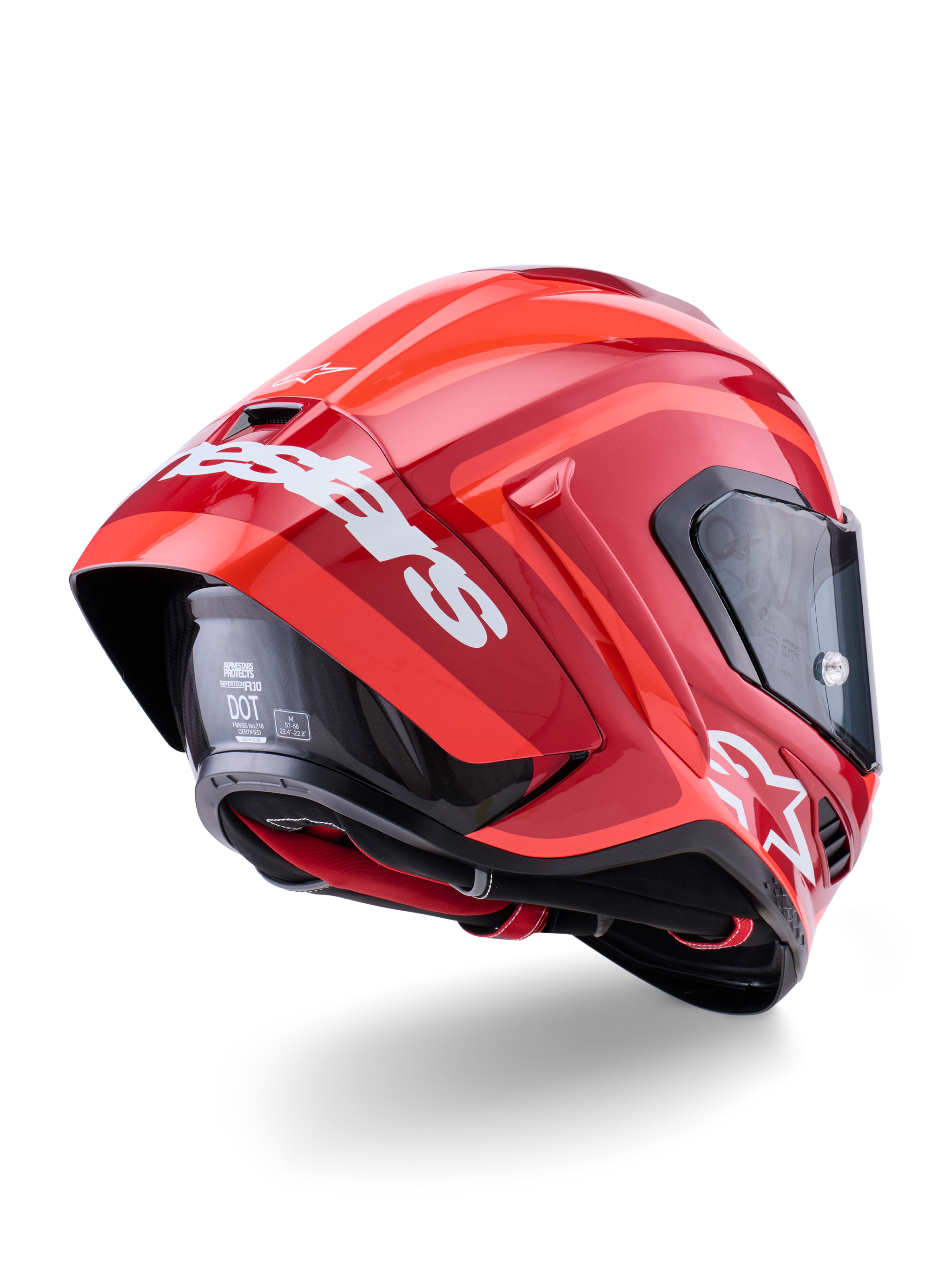 Alpinestars Supertech R10 Arius Helm, glanzend rood met witte branding, driekwart achteraanzicht met de aerodynamische spoiler, koolstofvezel schaalconstructie en een strak raceprofiel met een donker vizier.