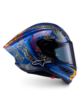 Supertech R10 Martinator Thai-helm van blauw carbon met gouden mandala-graphics en een aerodynamisch raceprofiel.