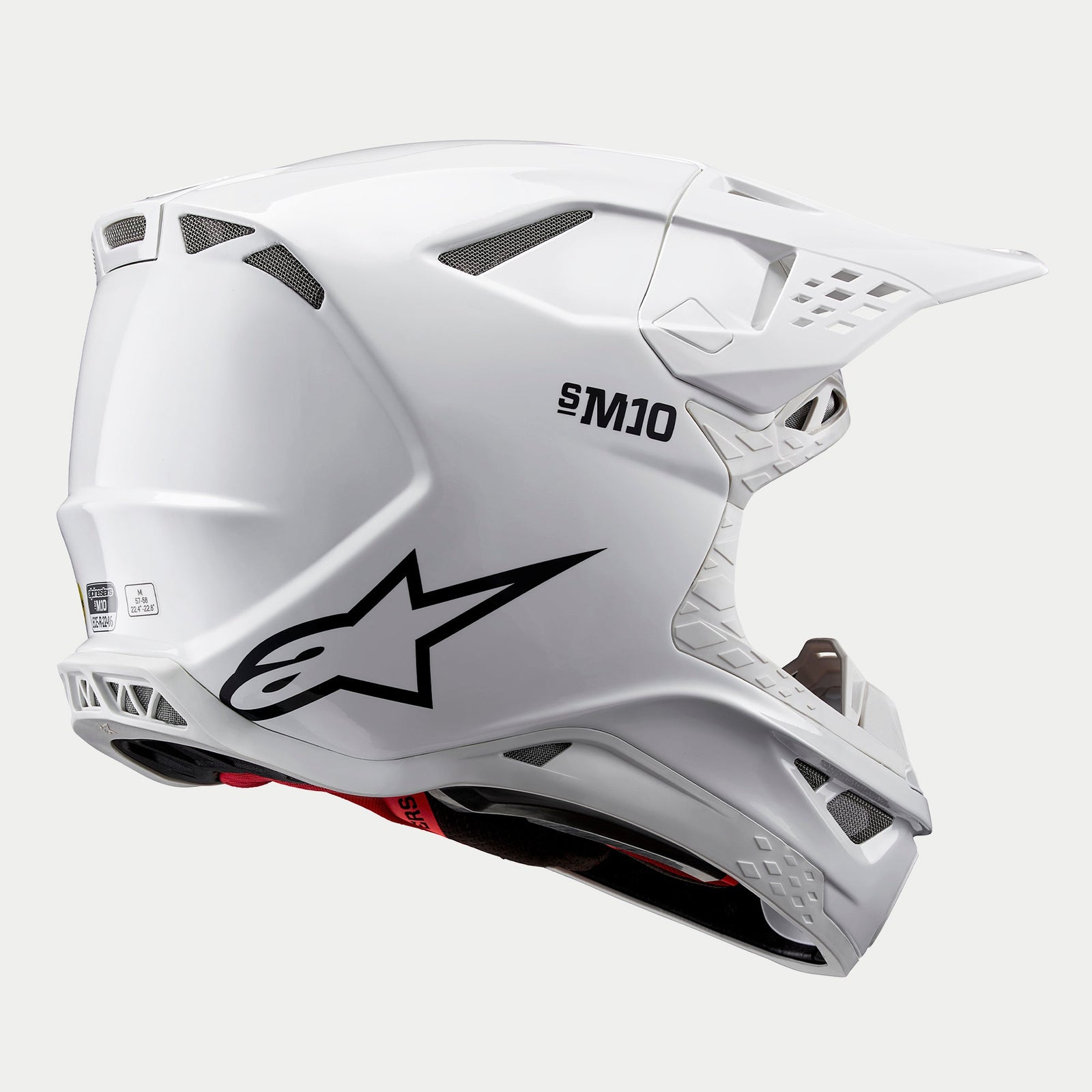 Alpinestars Supertech M10 Solid Helmet, Motocross Helmet, White Glossy, rear three-quarter view showing aerodynamic shell, black star logo and S-M10 branding, multiple ventilation ports for off-road racing