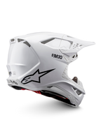 Alpinestars Supertech M10 Solid Helmet ECE 22.06, white glossy motocross helmet with black graphics, red accents, ventilation ports and peak visor