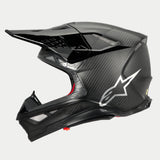 Alpinestars Supertech M10 Fame ECE 22.06 Helmet, Side Profile View, Black Carbon Matte and Glossy finish, featuring visible carbon fiber weave, silver Astars logo on the side, aerodynamic design with integrated ventilation ports and black visor