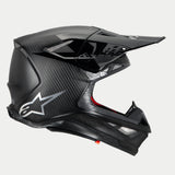 Alpinestars Supertech M10 Fame Helmet, Motocross Helmet, Black Carbon Matte and Glossy, side profile highlighting carbon fiber weave and silver Astars logo, aerodynamic design with multiple mesh-covered ventilation ports, high-performance off-road head protection