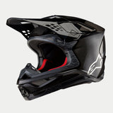 Alpinestars Supertech M10 Fame ECE 22.06 Helmet, Motocross Helmet, Black Carbon Matte and Glossy finish, featuring visible carbon fiber weave, white Astar logo on the side, and red interior padding, aerodynamic off-road design
