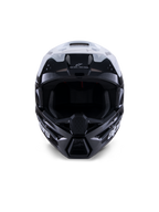 Alpinestars S-M3 Radium helm, motorcrosshelm, glanzend zwart, wit en grijs, vooraanzicht, voorzien van een agressief schaalontwerp met een wit vizier, zwarte kinbescherming en ventilatieopeningen met mesh-voering.