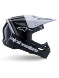 Alpinestars S-M3 Radium helm, motorcross off-road helm, glanzend zwart, wit en grijs, hoekig aerodynamisch ontwerp met ventilatieopeningen, zijaanzicht, glanzende afwerking met grijze strepen en een wit vizier met Alpinestars-branding