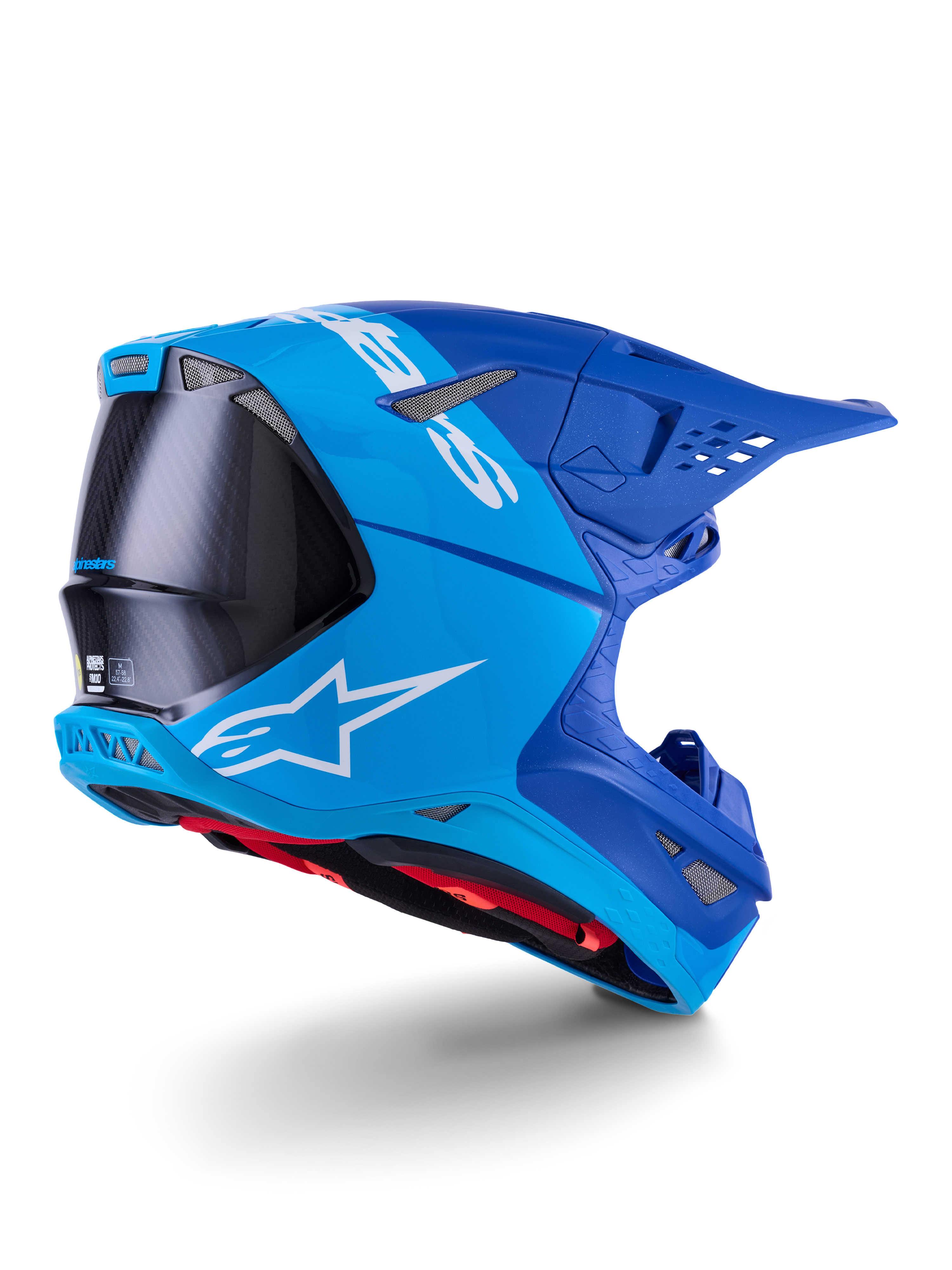 Alpinestars Supertech M10 Flood Helmet, Motocross Helmet, Bright Blue and Navy Blue with exposed Black Carbon fiber, rear-side profile showing ventilation ports and white logo, red interior lining, advanced aerodynamic design for off-road performance