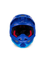 Alpinestars Supertech M10 Flood Helmet ECE, Motocross Helmet, Metallic and Medium Blue with black carbon accents, front-facing view showing chin bar and eye port, white Alpinestars logos and text, red interior padding, professional off-road protection