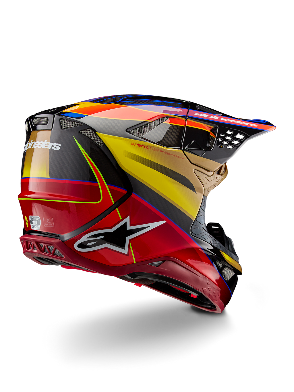 Alpinestars Supertech M10 Era helm, motorcross helm, Gold Yellow Rio Red Glossy, driekwart achteraanzicht met koolstofvezel schaal, rode en gele graphics, blauwe accenten, aerodynamisch profiel met meerdere ventilatieopeningen en opvallend Astar-logo.