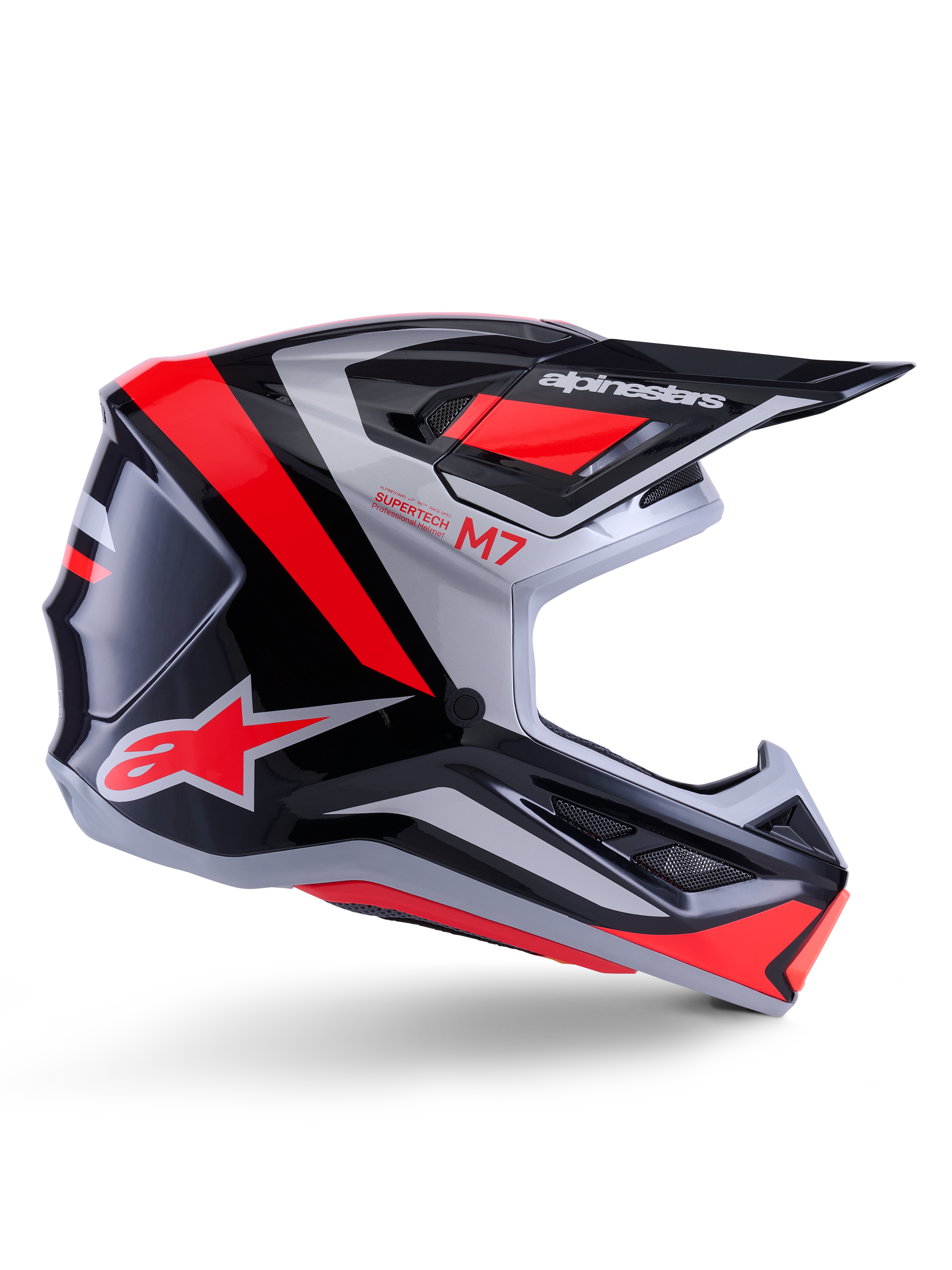 Alpinestars S-M7 Rise helm, motorcrosshelm, zwart zilver en rood fluo, zijaanzicht met hoekig aerodynamisch ontwerp met zonneklep en ventilatieopeningen, glanzende afwerking, Supertech M7-serie