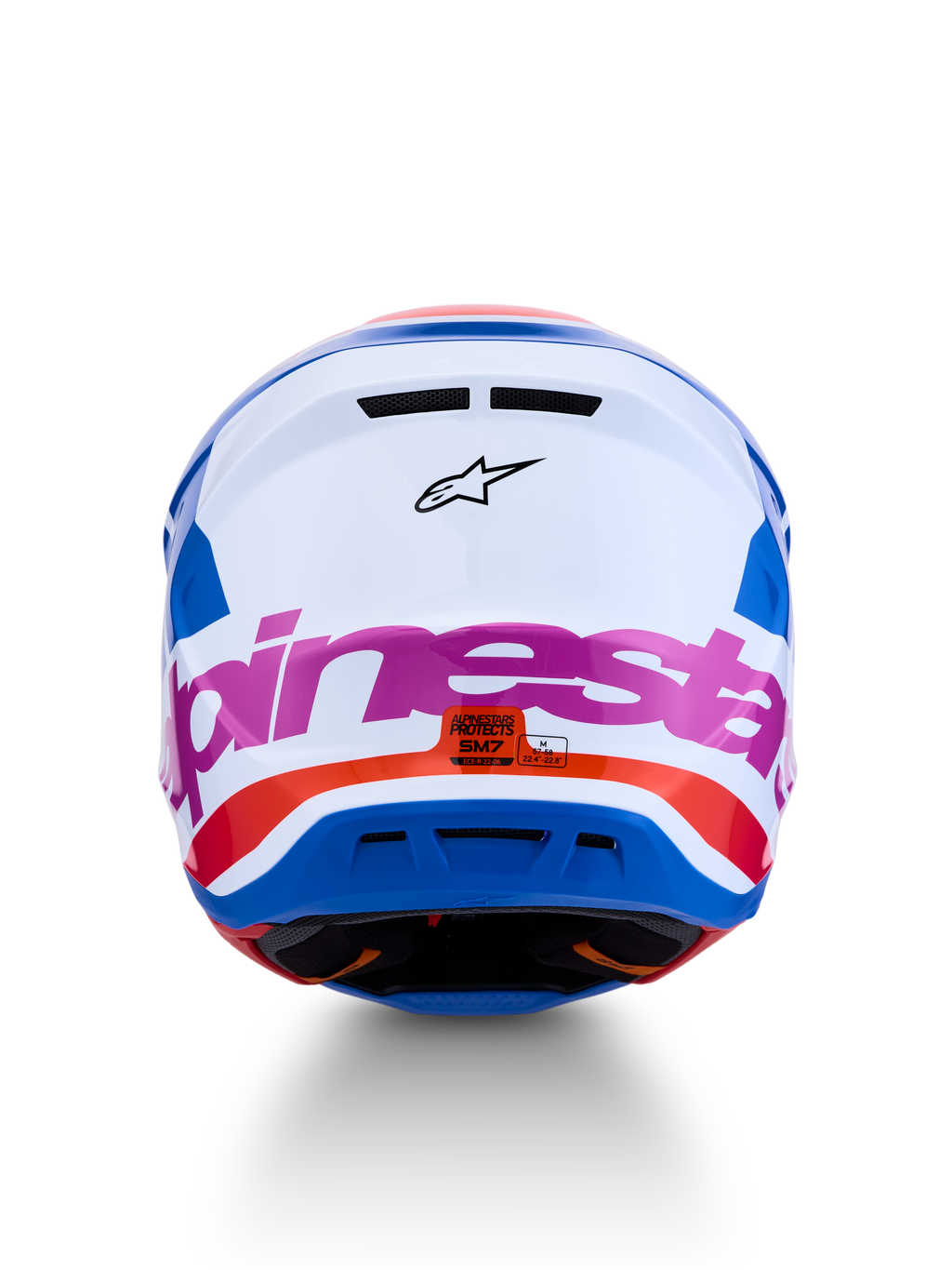 Alpinestars S-M7 Core motorcrosshelm in wit en blauw met roze en oranje accenten, ECE 22.06-gecertificeerd, achteraanzicht.