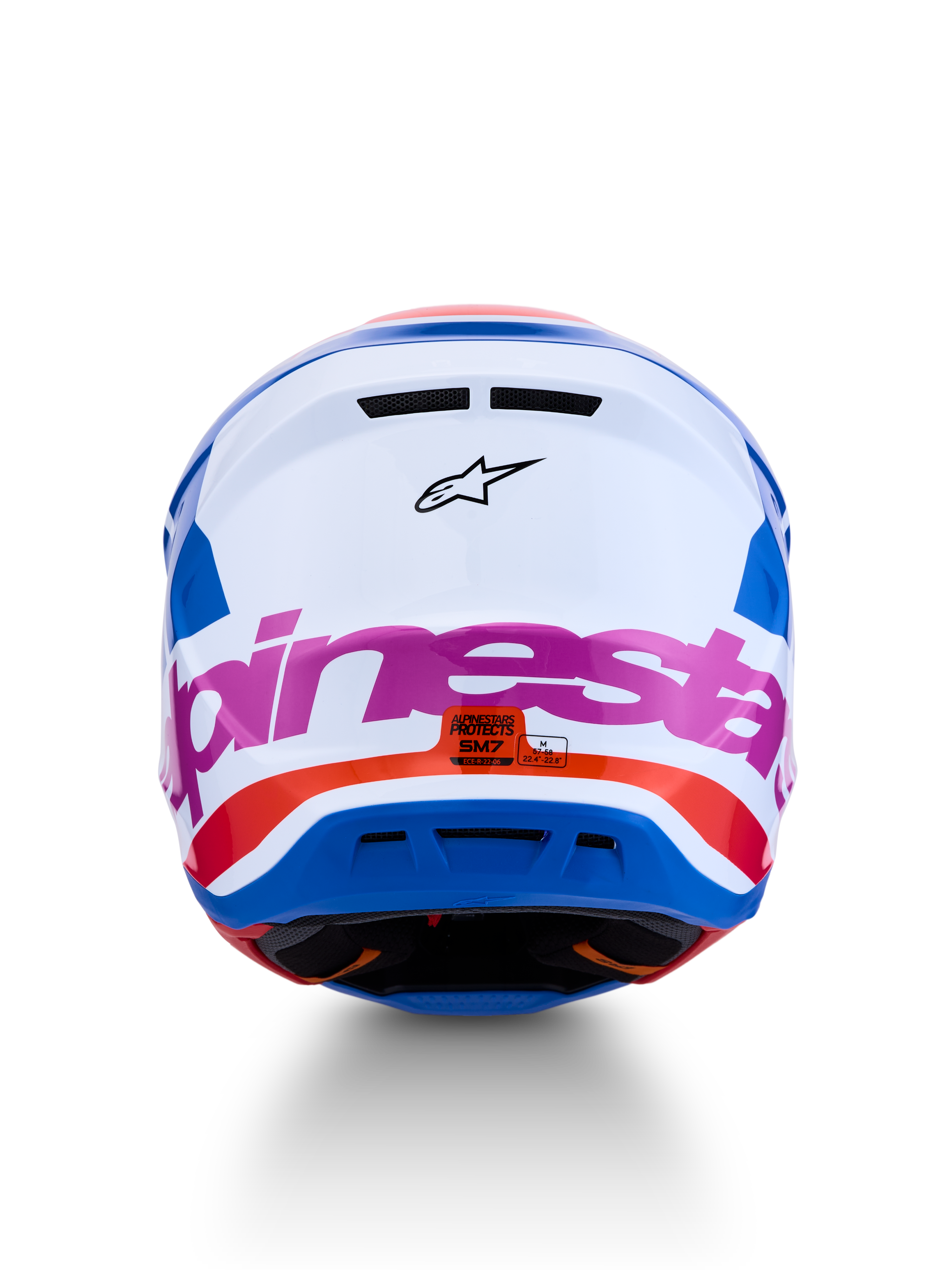 Alpinestars S-M7 Core motorcrosshelm in wit en blauw met roze en oranje accenten, ECE 22.06-gecertificeerd, achteraanzicht.
