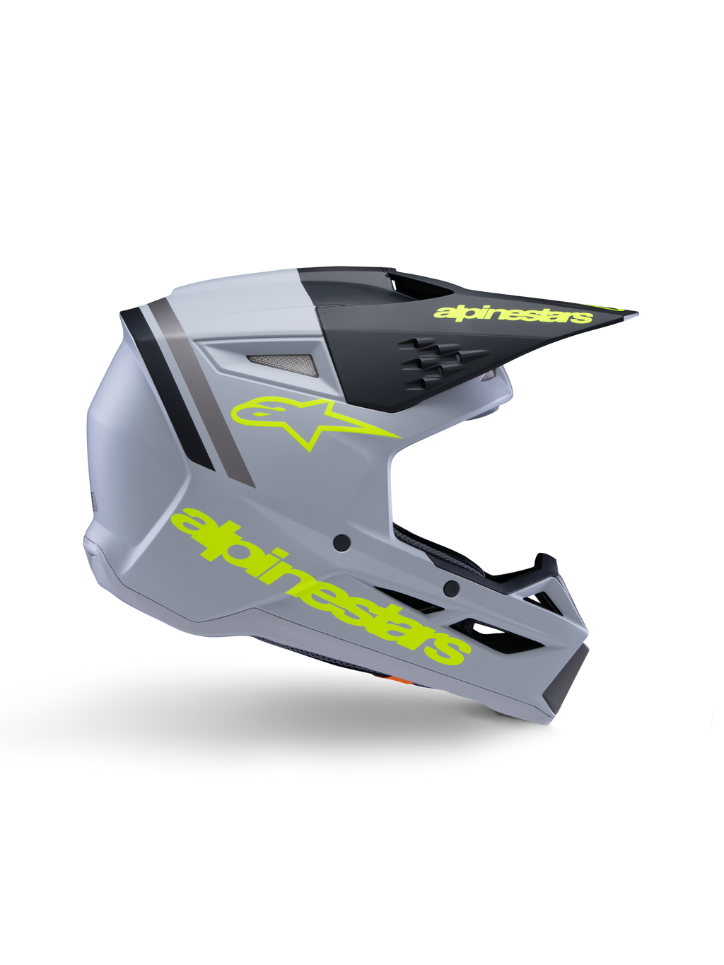 Alpinestars S-M3 Youth Radium helm ECE 22.06, jeugd motorcrosshelm, mat grijs en zwart met neongele branding, zijprofiel met Alpinestars-logo en tekst, aerodynamisch ontwerp met geïntegreerde ventilatie en zwart vizier.