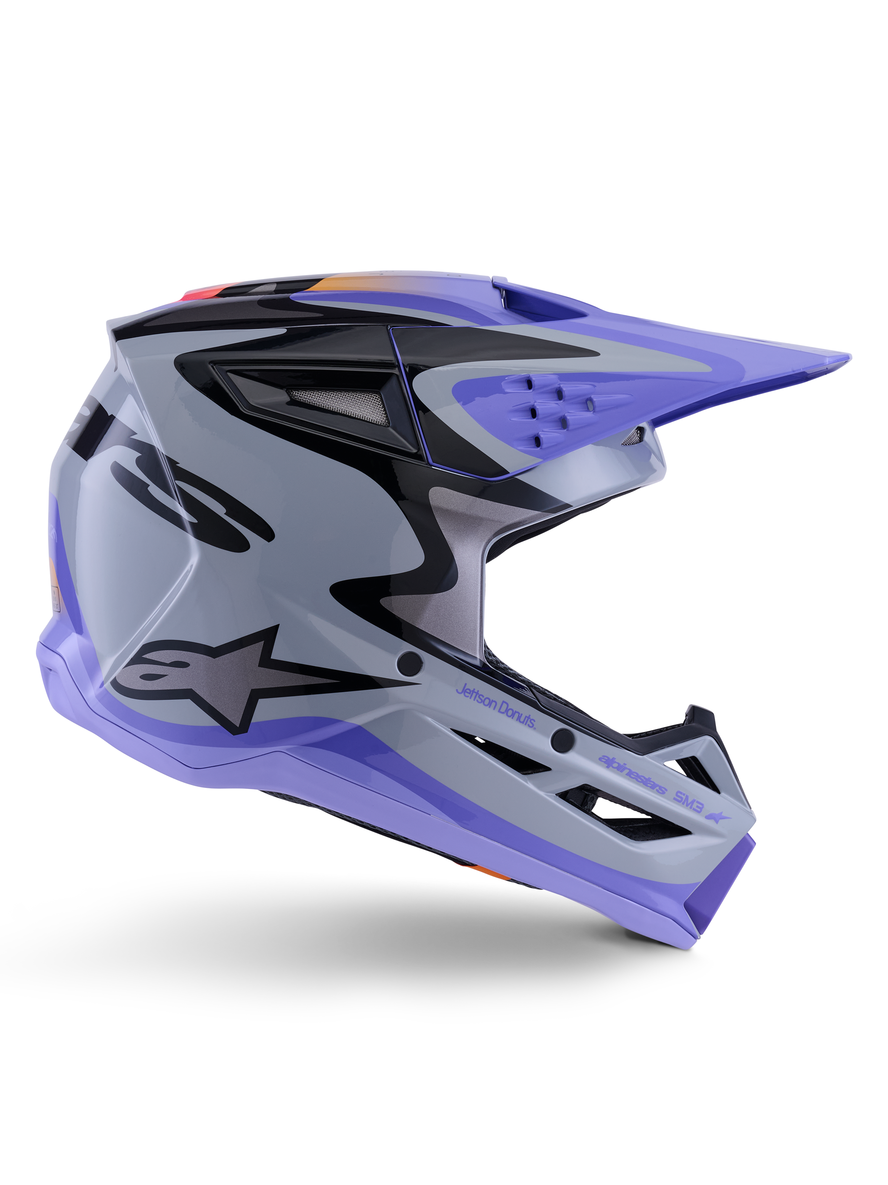 Alpinestars S-M3 Jettson Helm ECE 22.06, motorcrosshelm, grijs, paars en zwart glanzend, zijaanzicht met een paars vizier en kinstuk, slanke aerodynamische schaal met zwarte graphics, meerdere ventilatieopeningen en 'Jettson Donuts' branding aan de zijkant