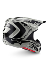 Alpinestars Limited Edition S-M7 Wolf Dust Helmet, Motocross Helmet, Dune Black Glossy, light gray shell with bold black Alpinestars graphics and Gothic-style text, streamlined aerodynamic design with multiple ventilation ports, red internal padding, high-performance off-road head protection