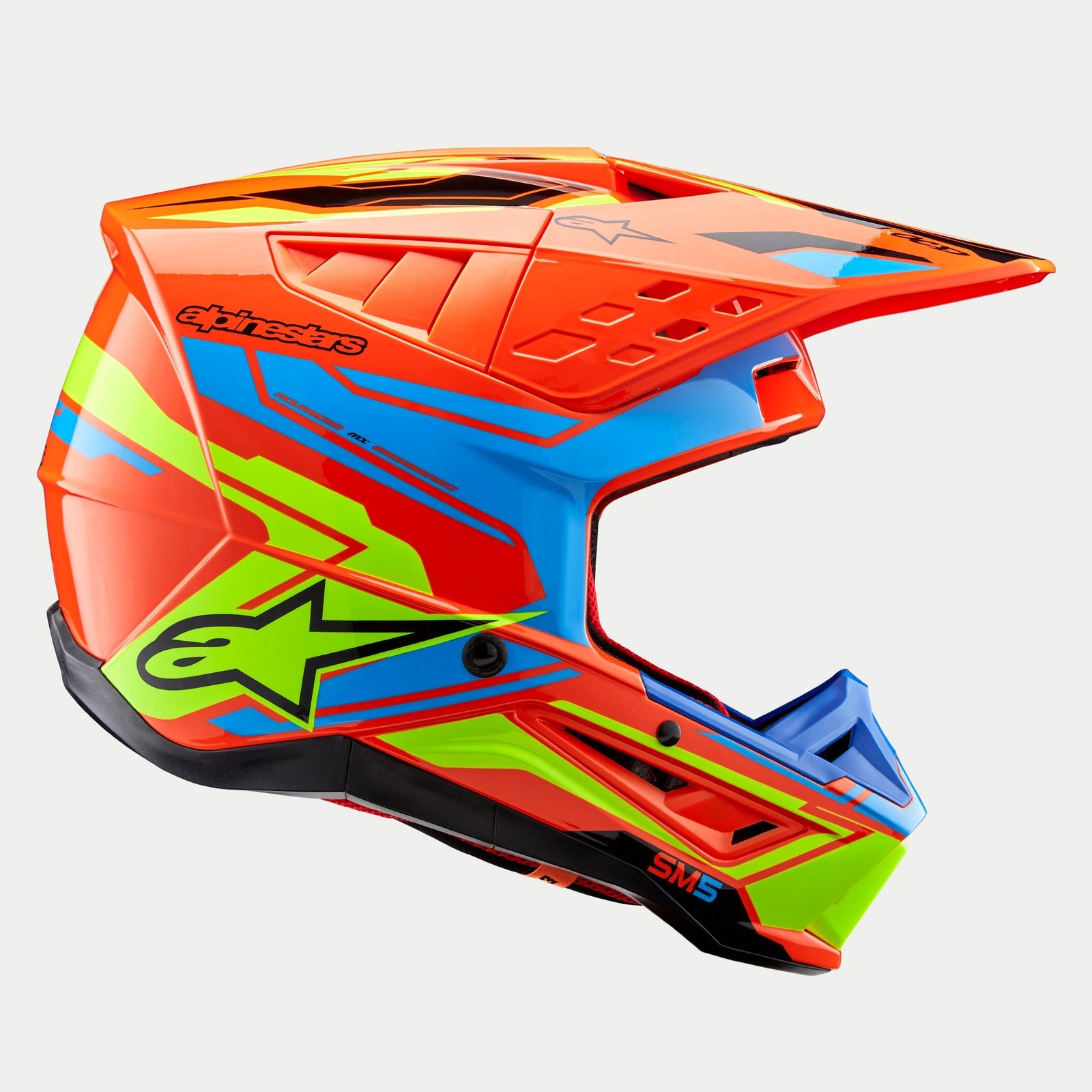 Alpinestars S-M5 Action 2 Helmet ECE, Motocross Helmet, Orange Fluo Cyan and Yellow Fluo, side profile view, vibrant glossy finish with Alpinestars star logo and SM5 branding, designed for off-road protection