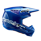 Alpinestars S-M5 Corp Helmet ECE, Blue Glossy motocross helmet, side profile view, bold white Alpinestars branding across the side, purple accents in ventilation ports, lightweight aerodynamic shell for off-road performance