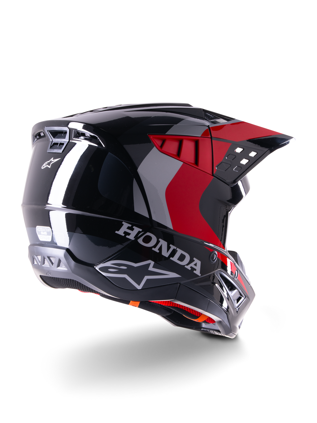 Alpinestars Honda S-M5 ECE helm, motorcrosshelm, glanzend zwart met rood, driekwart achteraanzicht met Honda-branding en Alpinestars-logo's, rode en grijze grafische accenten, ontworpen voor off-road bescherming