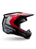 Honda S-M5 helm, motorcrosshelm, glanzend zwart en rood met witte en zilveren accenten, zijaanzicht met Honda- en Alpinestars-logo's, aerodynamisch ontwerp met vizier en diverse ventilatieopeningen, professionele off-road beschermende uitrusting