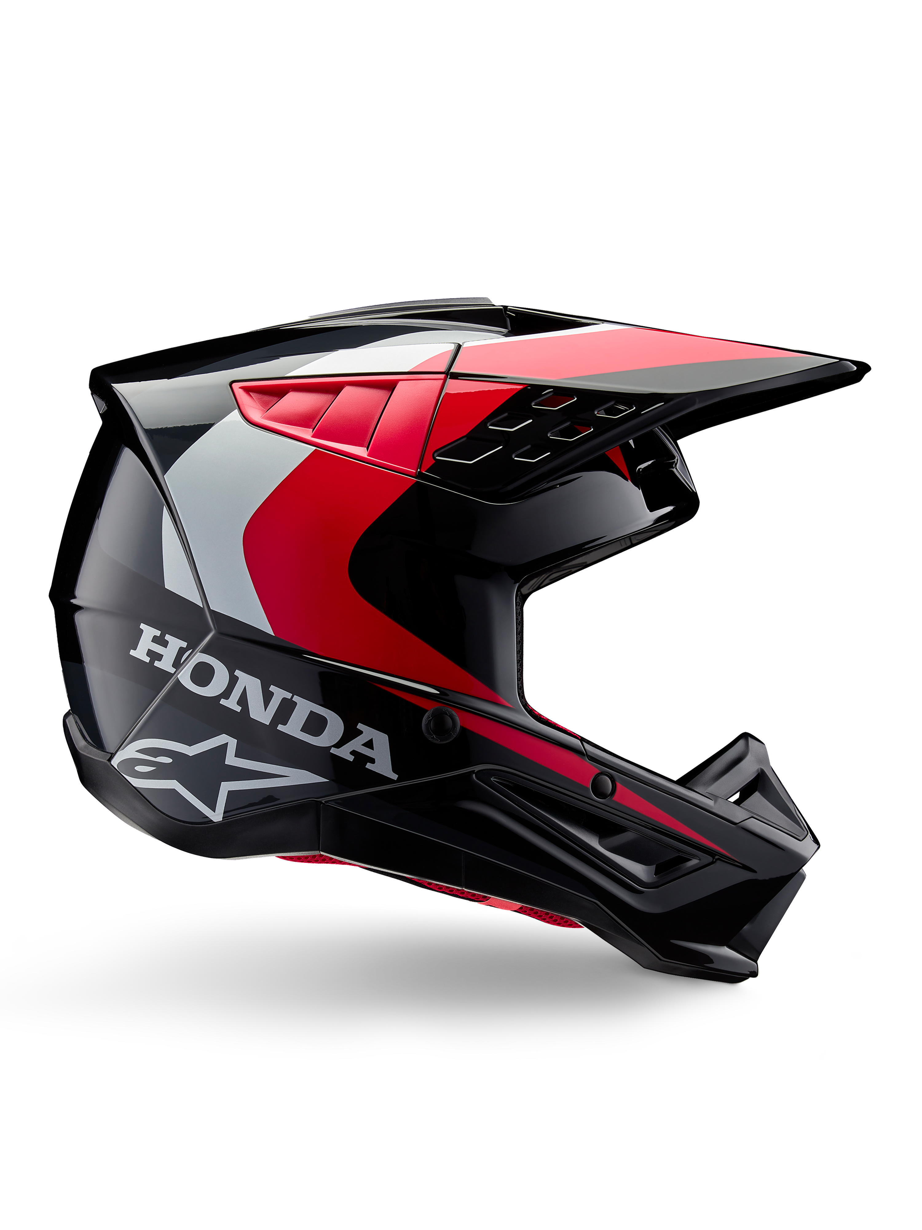 Honda S-M5 helm, motorcrosshelm, glanzend zwart en rood met witte en zilveren accenten, zijaanzicht met Honda- en Alpinestars-logo's, aerodynamisch ontwerp met vizier en diverse ventilatieopeningen, professionele off-road beschermende uitrusting