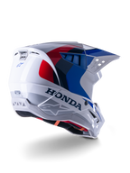 Alpinestars Honda S-M5 Helmet ECE, Motocross Helmet, White Blue and Red Glossy, featuring bold Honda branding and Alpinestars logos, aerodynamic shell with integrated ventilation ports and adjustable visor, protective gear for off-road racing