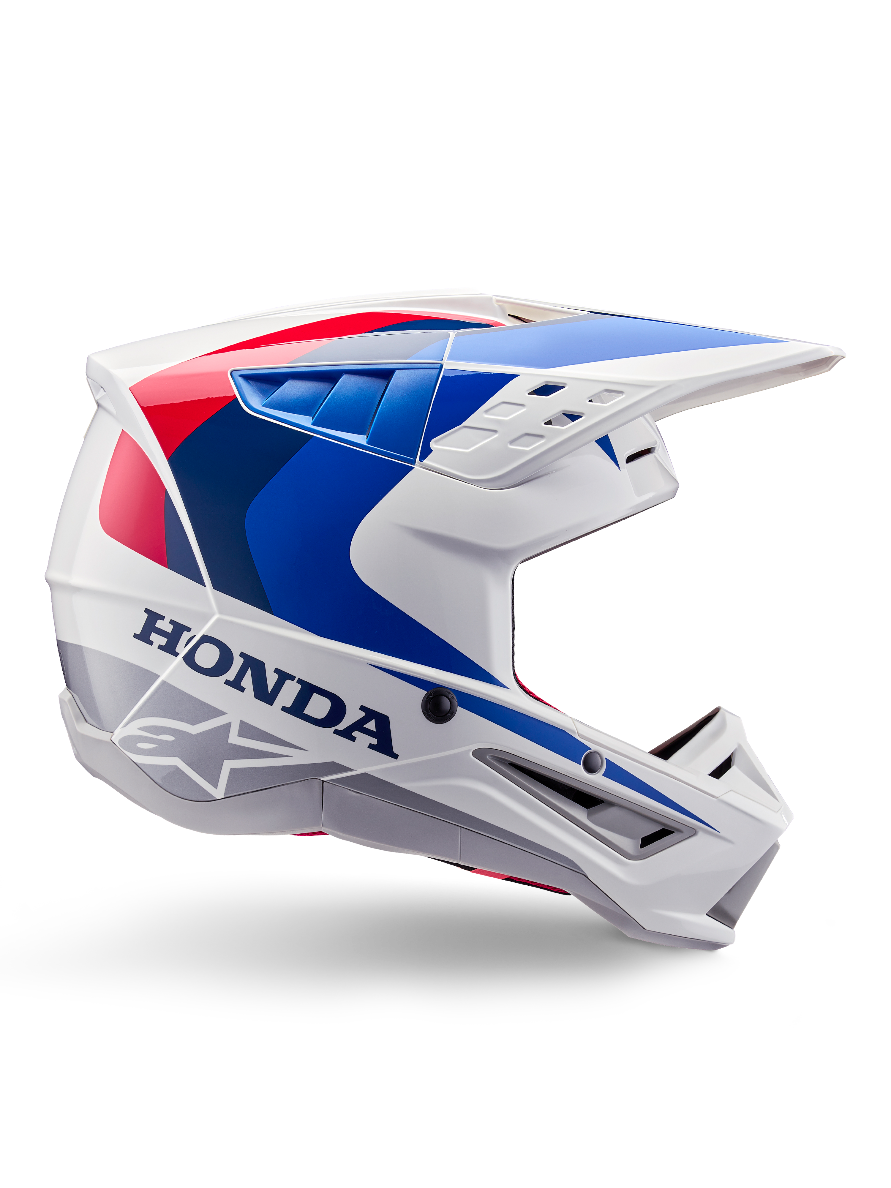 Alpinestars Honda S-M5 helm ECE, motorcrosshelm, wit, blauw en rood, zijaanzicht, aerodynamisch ontwerp met geïntegreerd vizier, meerdere ventilatieopeningen, glanzende afwerking, opvallende Honda branding en Alpinestars logo