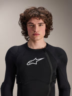 Male model wearing Alpinestars A-Impact Plasma Protection Jacket - Long Sleeve, Black with white Astars logo, featuring an offset front zipper and integrated padding, professional MTB protection gear