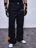 RSRV Arena Suit Pants, Black Racing Pants with McLaren and Alpinestars Logos, Orange Side Patches, Premium Motorsport Apparel, Worn with Black and Orange Gloves and White Racing Shoes