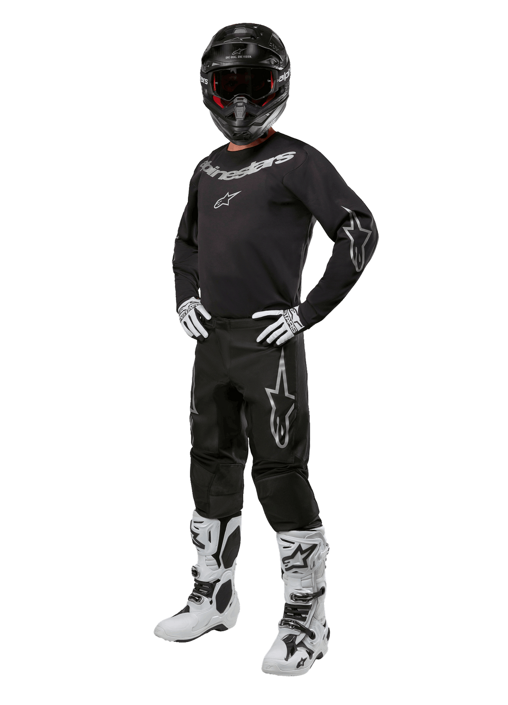 Alpinestars 2024 Fluid Graphite Gear Set, complete motorcross outfit, zwart met grijze en witte logo's, inclusief jersey en broek gedragen met bijpassende zwarte helm, witte en zwarte handschoenen en laarzen, ontworpen voor off-road bescherming