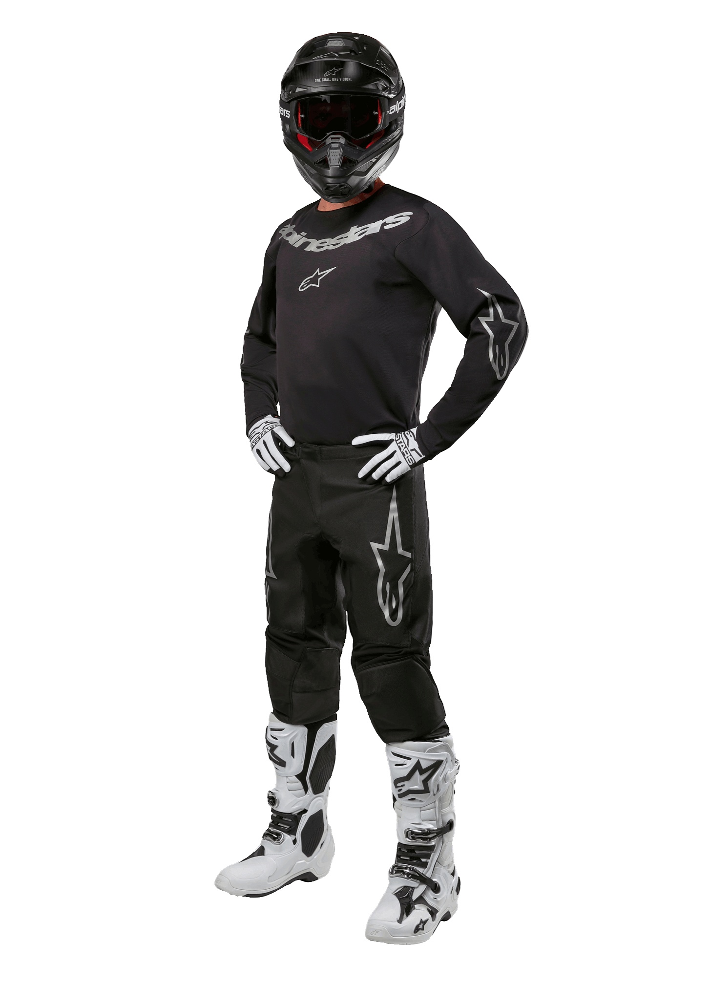 Alpinestars 2024 Fluid Graphite Gear Set, complete motorcross outfit, zwart met grijze en witte logo's, inclusief jersey en broek gedragen met bijpassende zwarte helm, witte en zwarte handschoenen en laarzen, ontworpen voor off-road bescherming