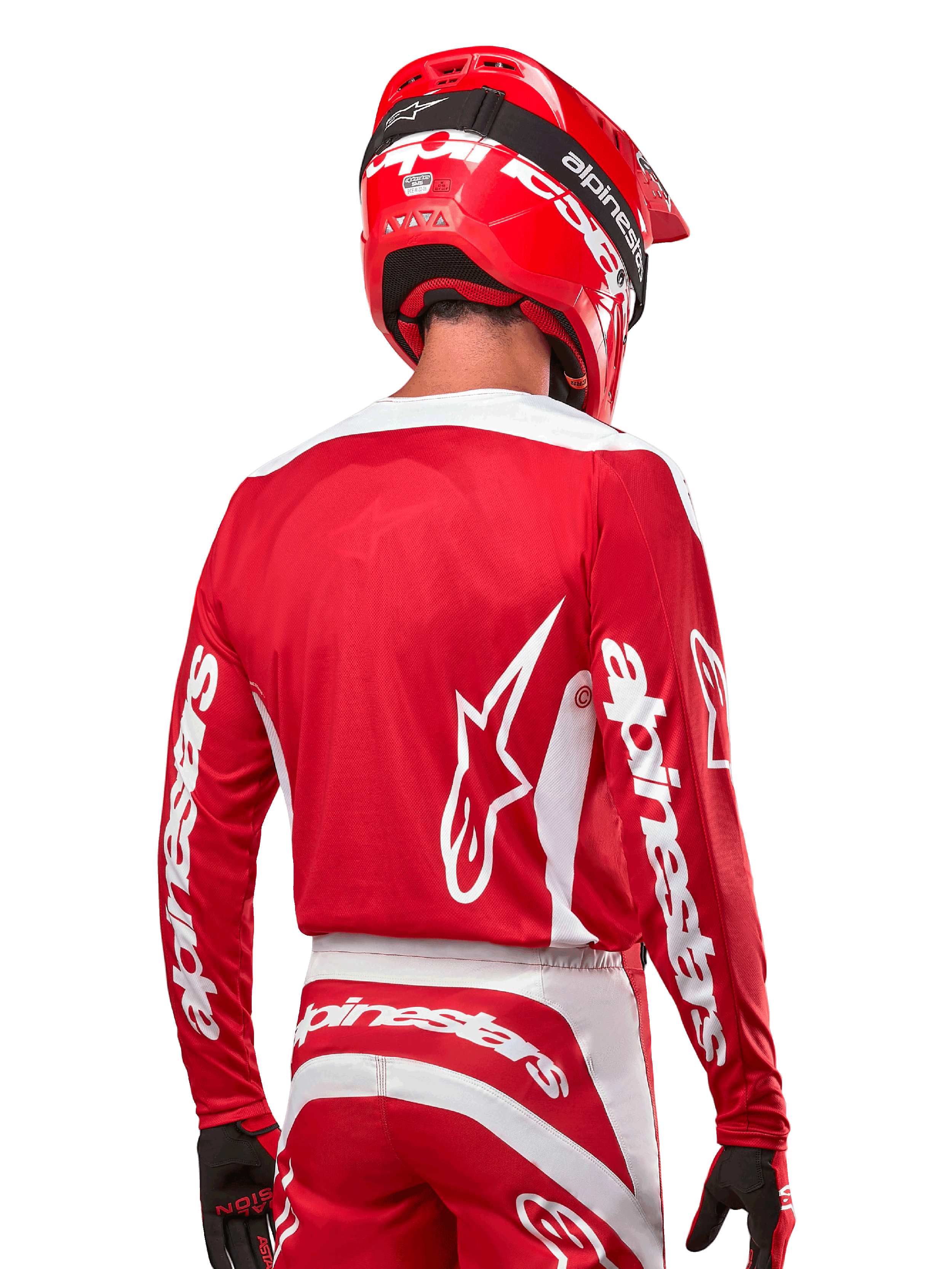 Alpinestars 2024 Fluid Lurv Jersey, motorcross shirt, Mars Red en wit, achteraanzicht met wit Alpinestars-logo op de rug en branding op de mouwen, gecombineerd met een bijpassende rode helm en zwarte handschoenen, professionele off-road race-uitrusting