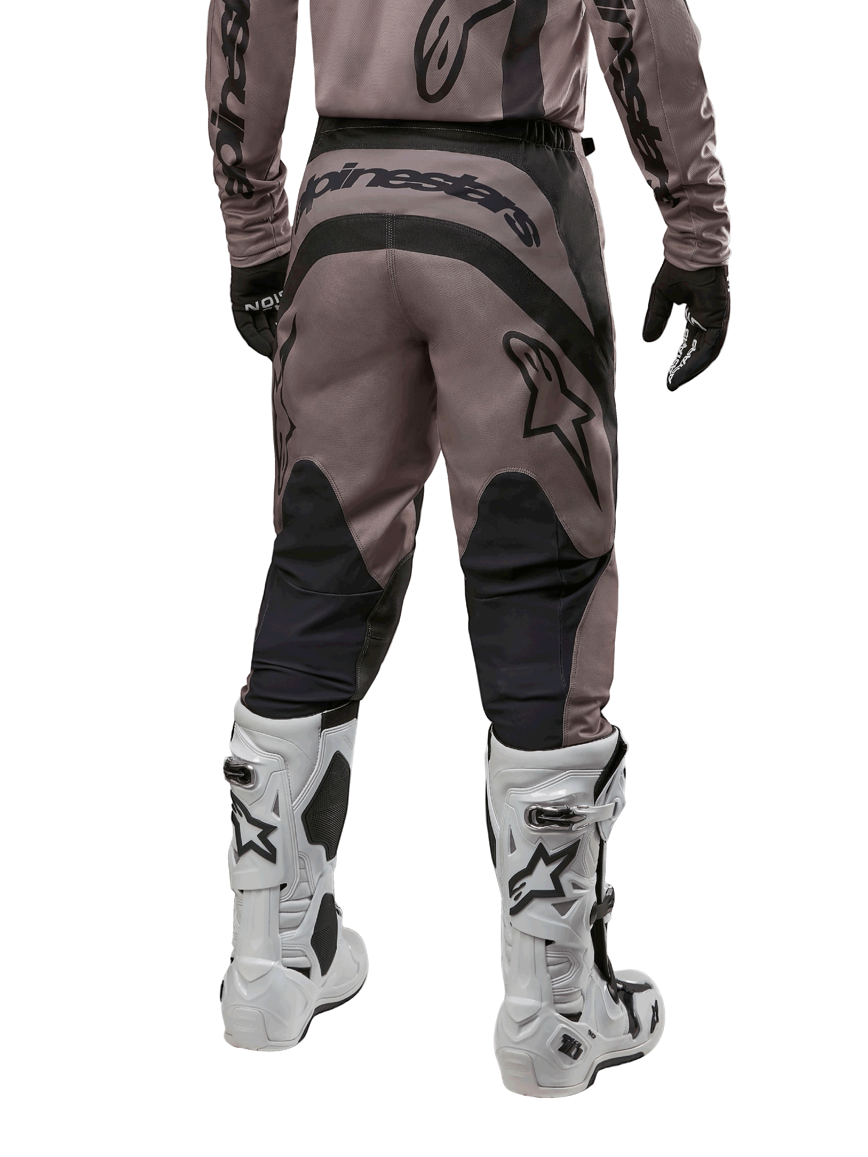 Alpinestars 2024 Fluid Lurv crossbroek, motorcross broek, Mud Black, achteraanzicht met groot zwart Alpinestars-logo op het zitvlak en zwarte kuitpanelen, gedragen met wit-zwarte motorcrosslaarzen en bijpassende jersey.