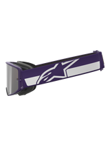 Alpinestars Limited Edition HUNTA96 XXV Supertech Vision Goggles, motocrossbril, paars en wit, zijaanzicht met brede paarse band met wit Alpinestars sterlogo en streep, zilveren spiegelglas, hoogwaardige off-road eyewear