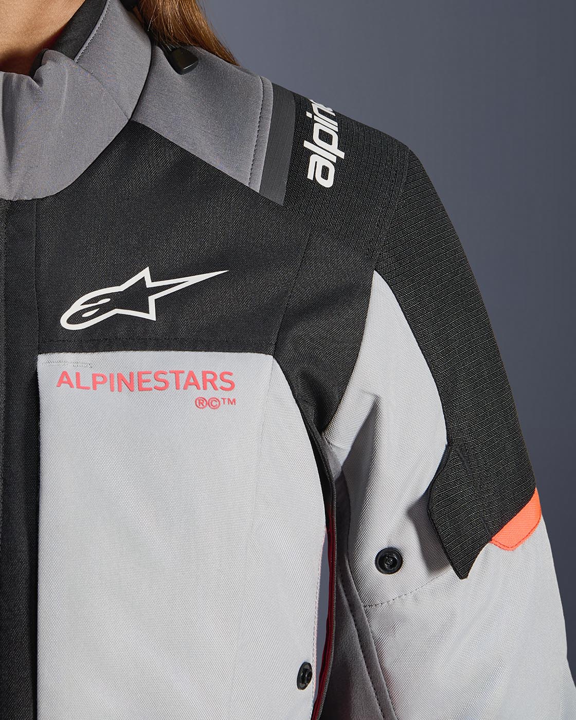 Alpinestars Stella Andes V4 Drystar women's adventure motorcycle jacket in gray and black with coral fluo accents.